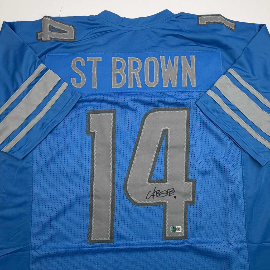 Autographed/Signed Amon-Ra St. Brown Detroit Blue Football Jersey Beckett BAS COA