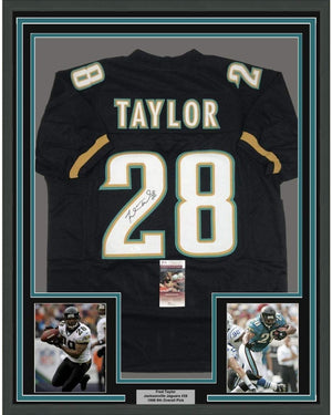 Framed Autographed/Signed Fred Taylor 35x39 Jacksonville Black Football Jersey JSA COA