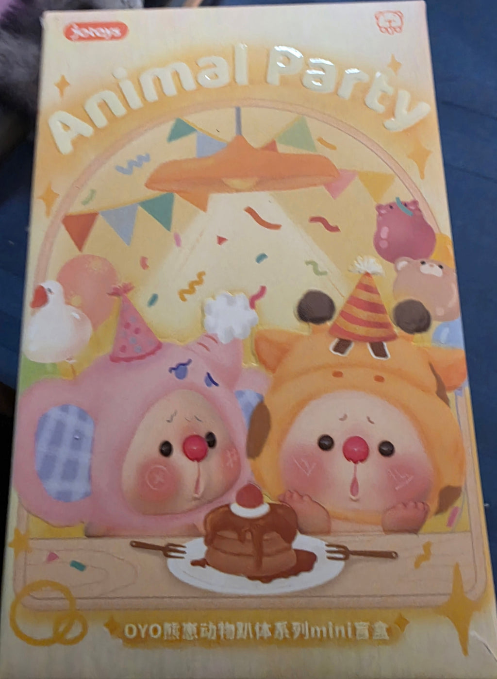 Children's toy packaging with cartoon animals and festive design