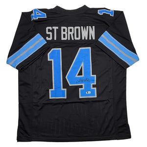 Autographed/Signed Amon-Ra St. Brown Detroit Black Football Jersey Beckett BAS COA