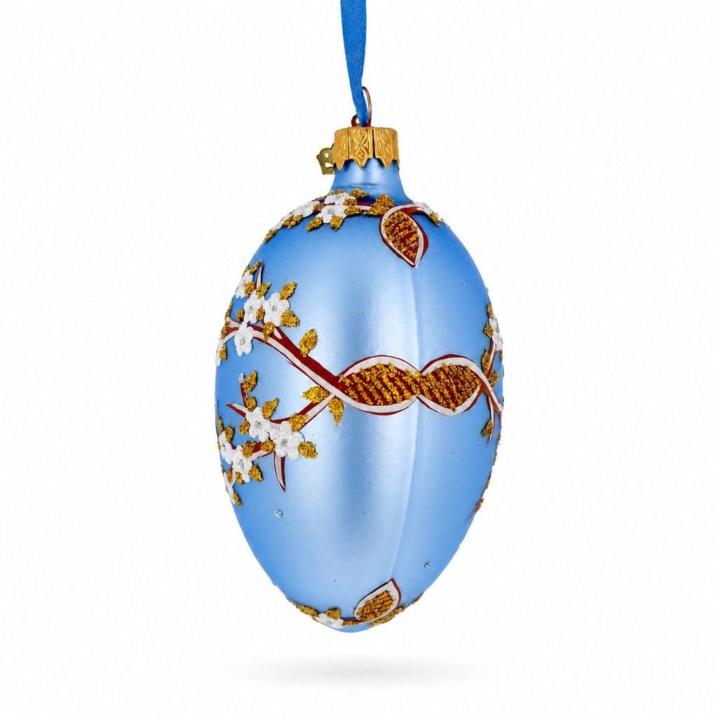 White Blossom Branch on Light Blue Glass Egg Ornament