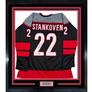 Framed Autographed/Signed Logan Stankoven 35x39 Carolina Black Hockey Jersey Beckett BAS COA