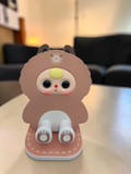 Momof2boyz Shop Baby Three BB3 brown bear character phone and display stand with a stable base on a table.