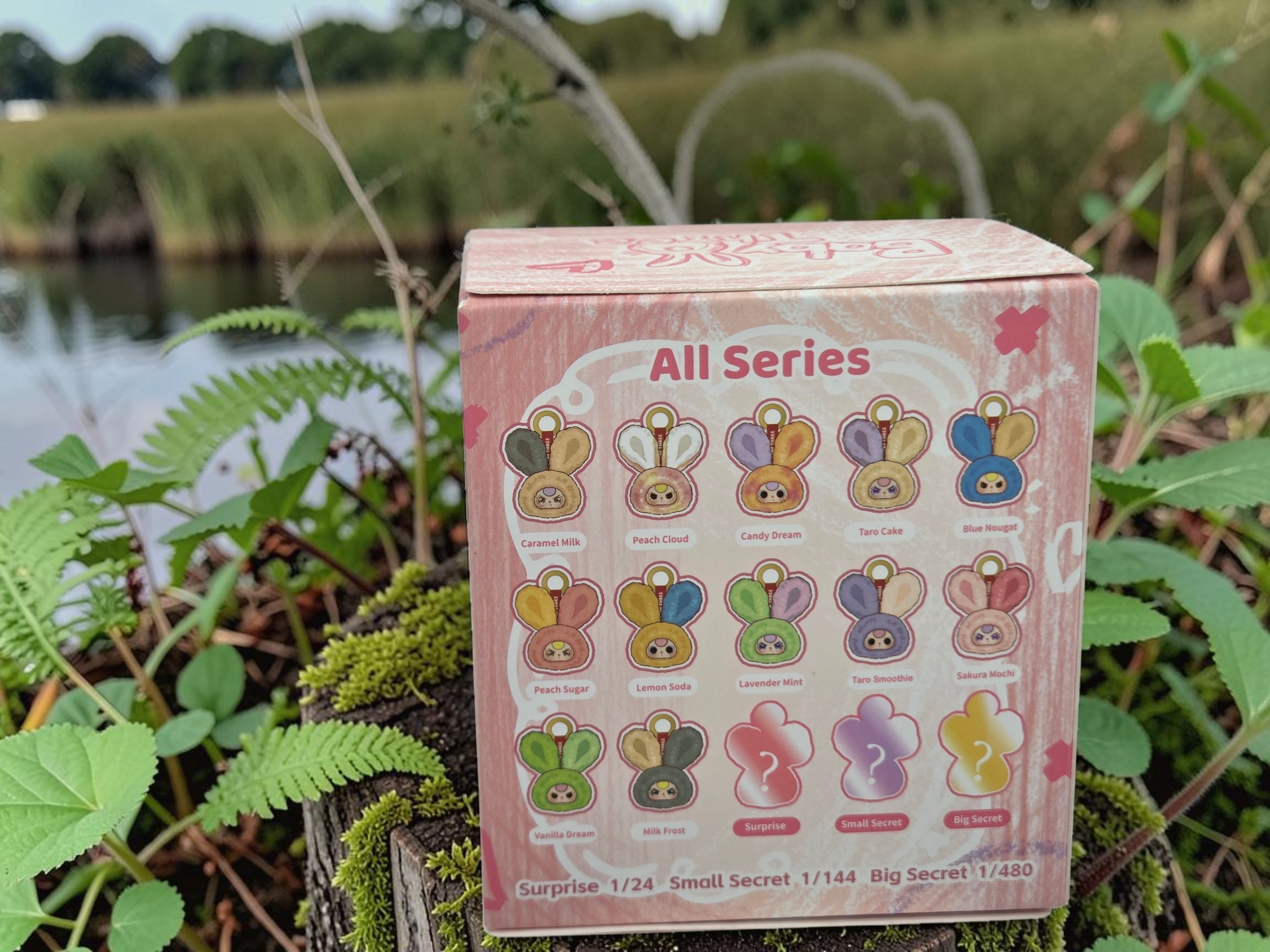 Momof2boyz Shop Baby Three Petit Macaron blind box featuring cute bunny head designs in various candy-themed colors.
