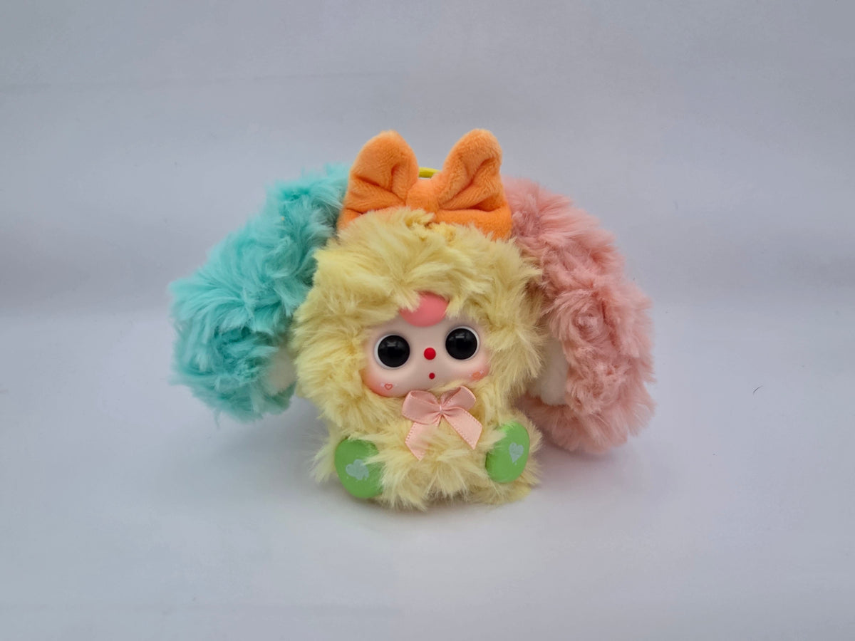 Momof2boyz Shop Baby Three Alice Rabbit Town plush keychain with yellow fur, orange bow, and pastel ear accents.