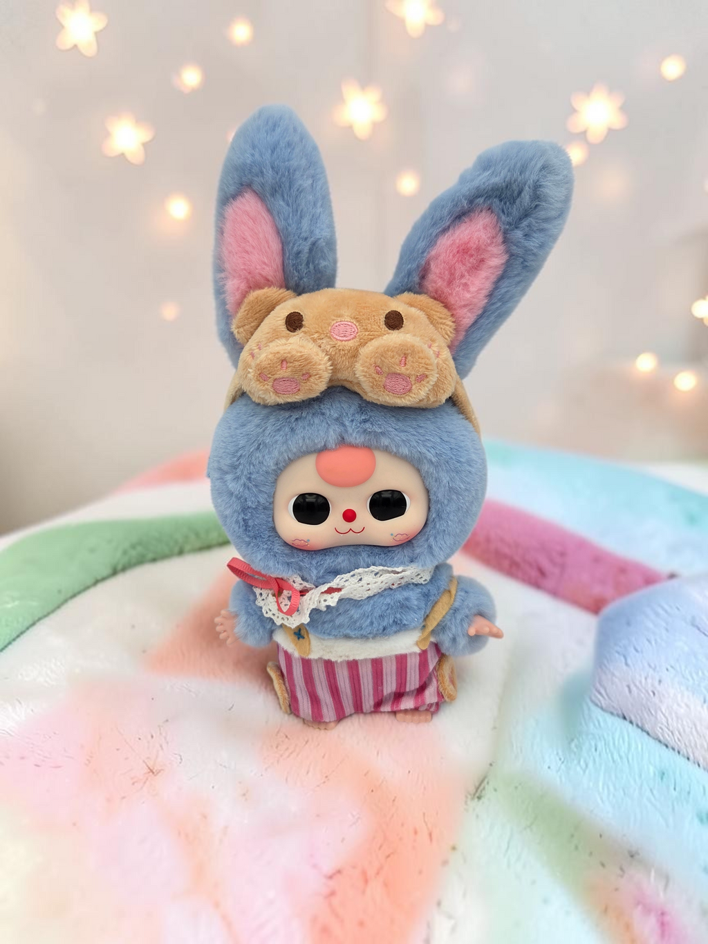 Momof2boyz Shop Baby Three Sweet Dreams plush rabbit figure wearing a blue fuzzy hood with pink striped pants