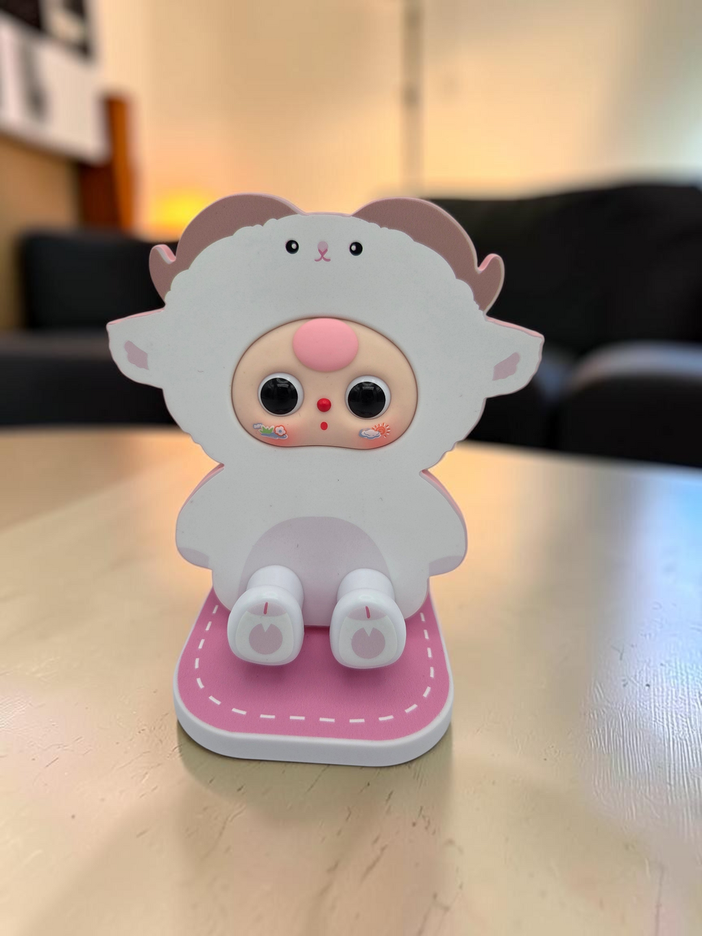 Momof2boyz Shop Baby Three BB3 TV stand featuring a cute white sheep character design with a pink base on a table.