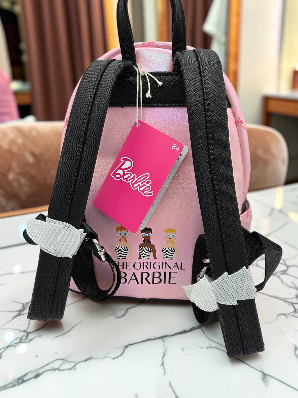 Momof2boyz Shop Loungefly Barbie mini backpack featuring a pink quilted back with The Original Barbie graphic print