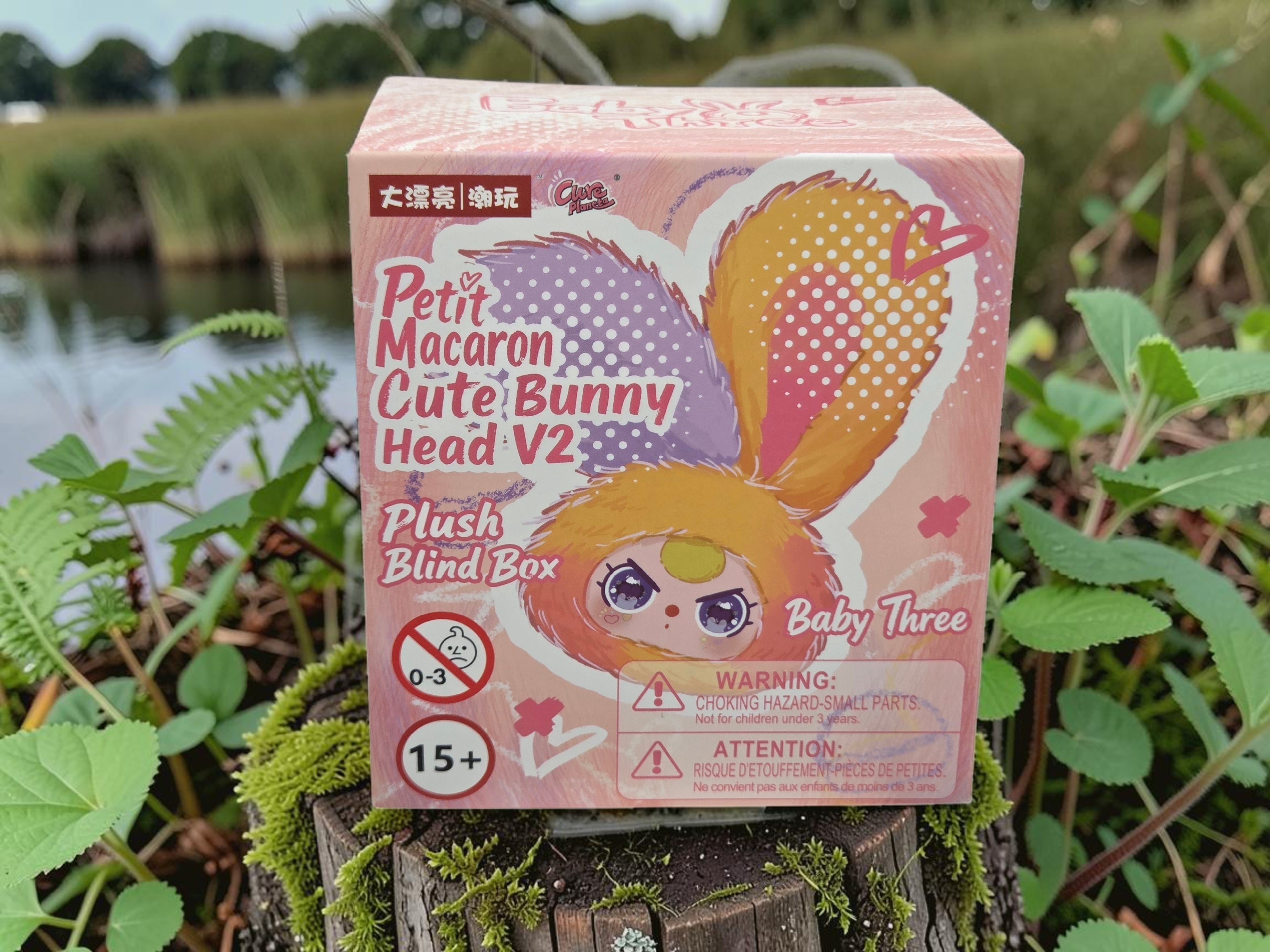 Momof2boyz Shop Baby Three Petit Macaron Cute Bunny Head V2 plush blind box with purple and orange ears.