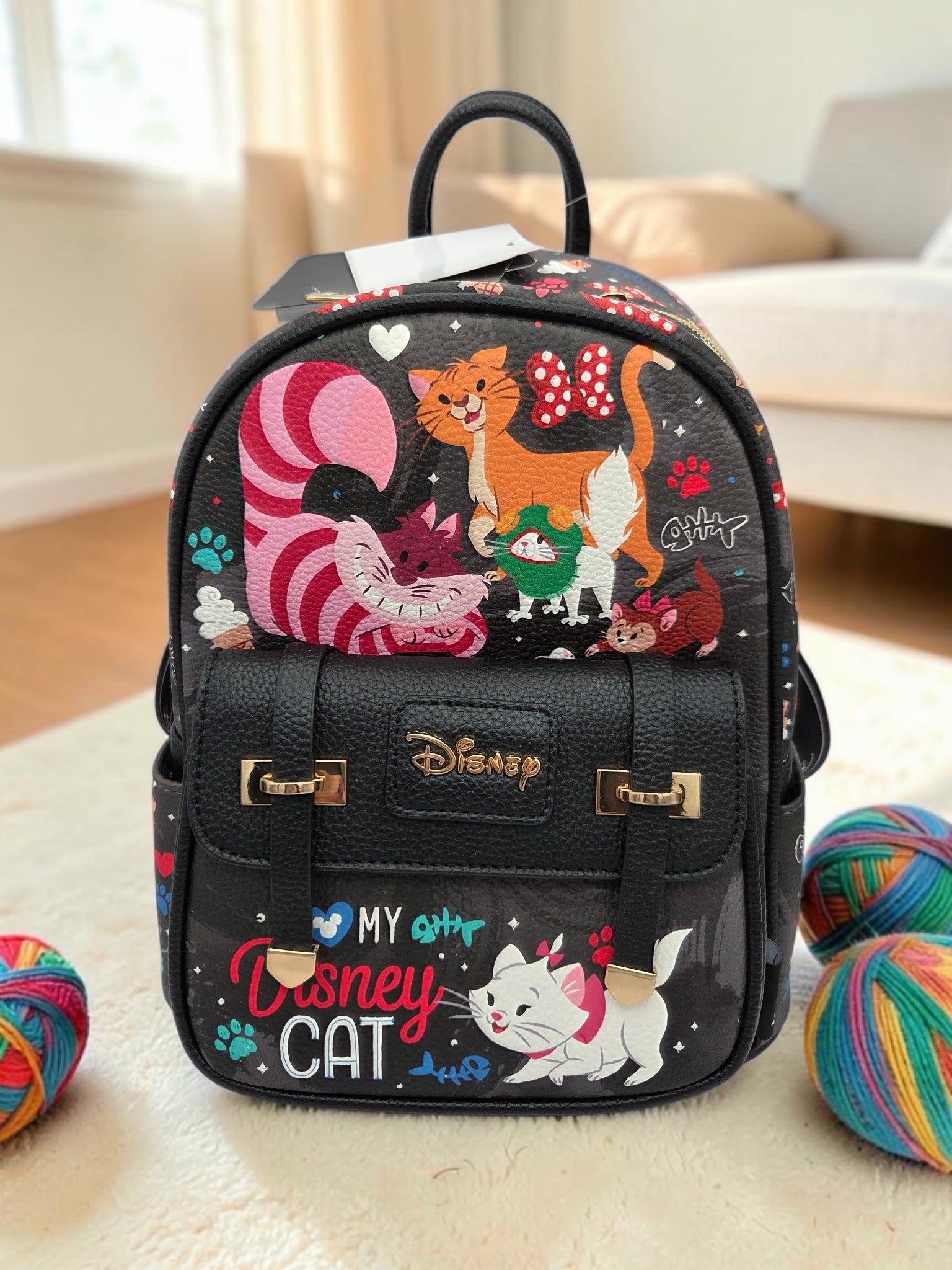 Momof2boyz Shop Disney cat mini backpack in black vegan leather with Marie and Cheshire Cat print and gold hardware.