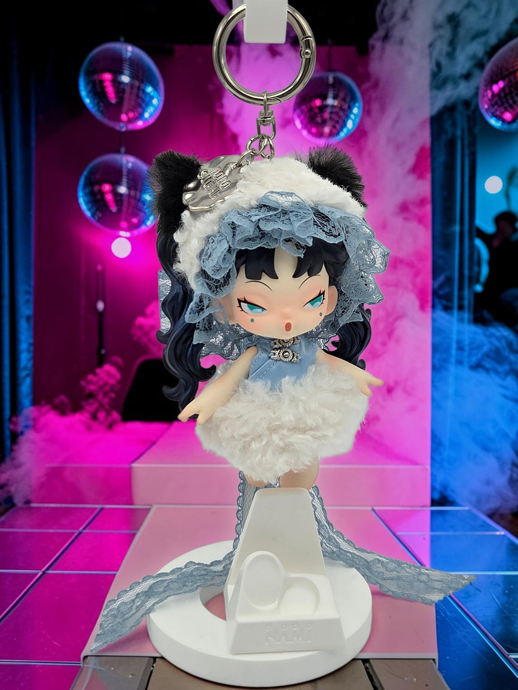 Momof2boyz Shop Dodo Nami Midnight Disco collectible keychain featuring a doll in a blue dress and lace bonnet.