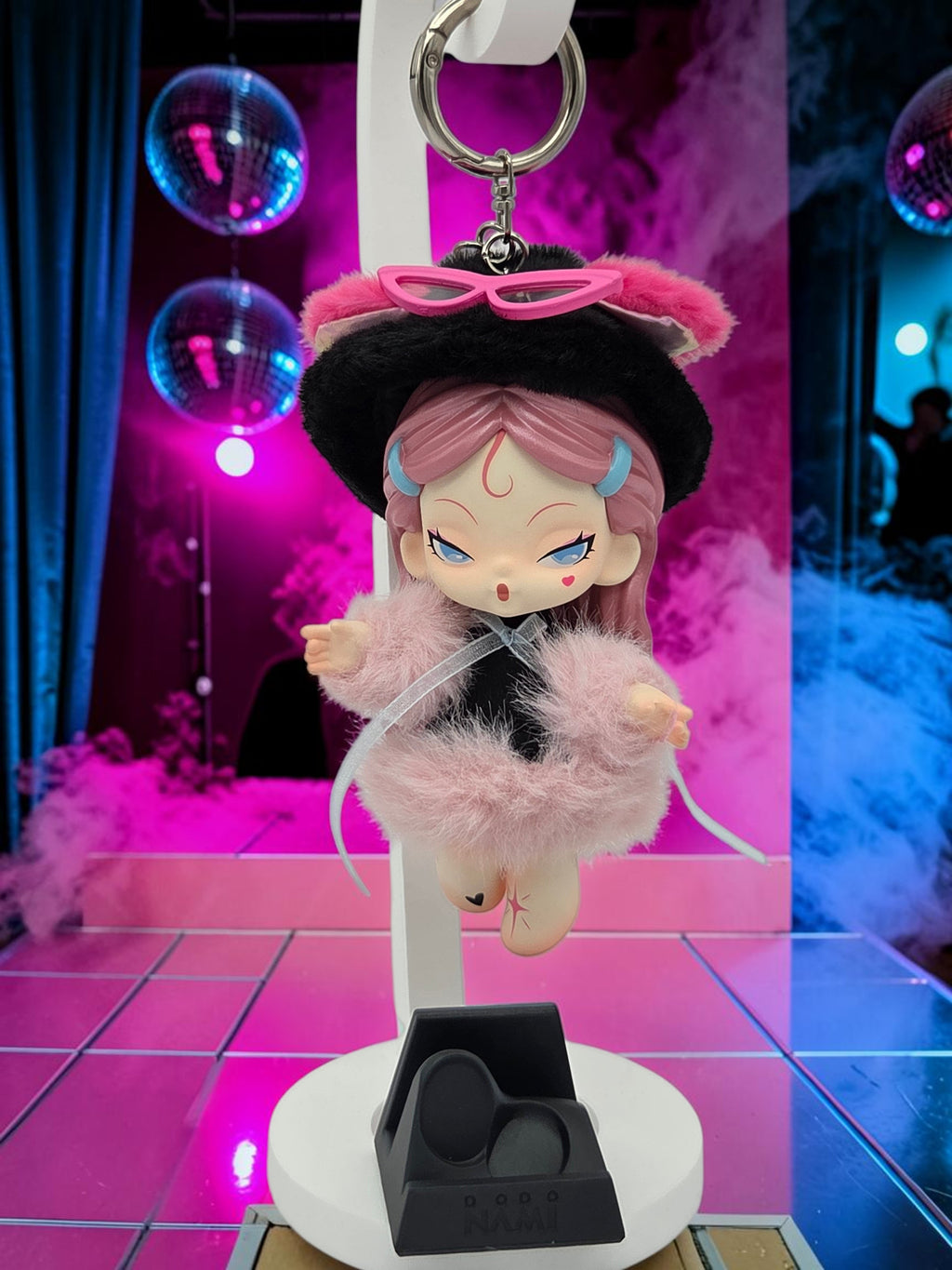 Momof2boyz Shop Dodo Nami Midnight Disco collectible keychain featuring a pink-haired character in a fuzzy coat