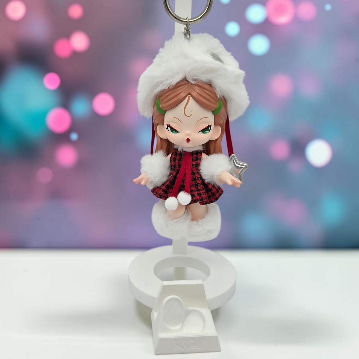 Momof2boyz Shop Dodo Nami Cheers Day collectible keychain figure wearing a red plaid dress and white faux fur hat.