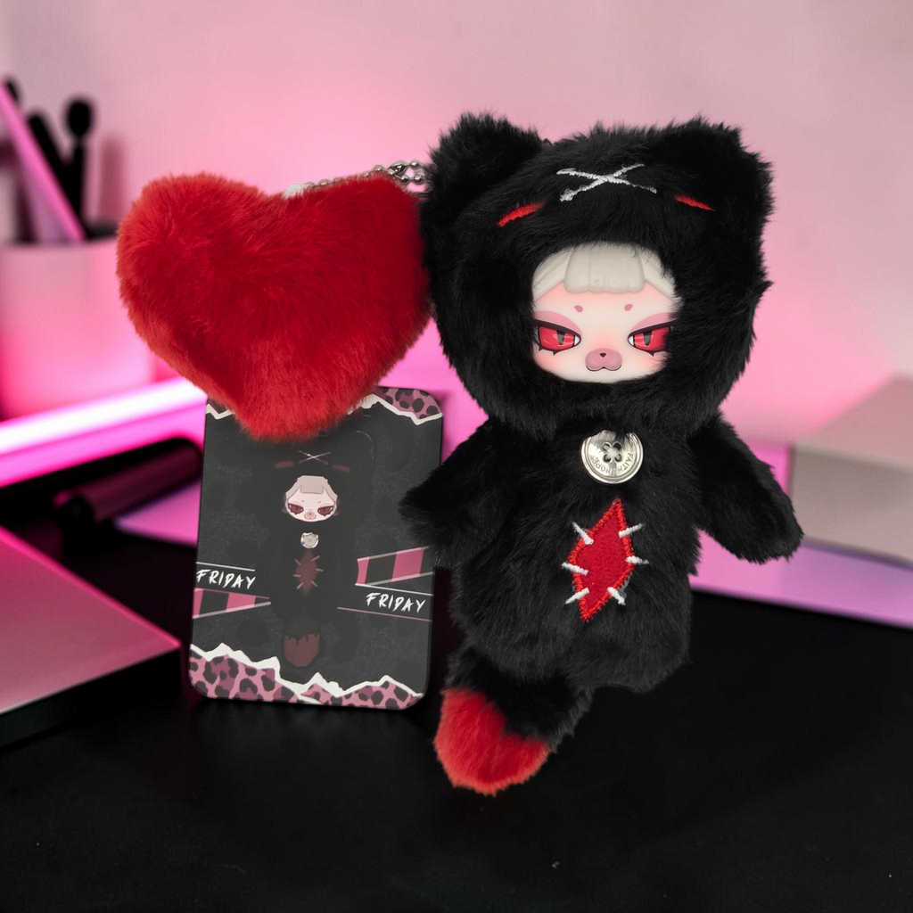 Momof2boyz Shop Friday plush keychain with black faux fur, red accents, heart charm, and character collector card.