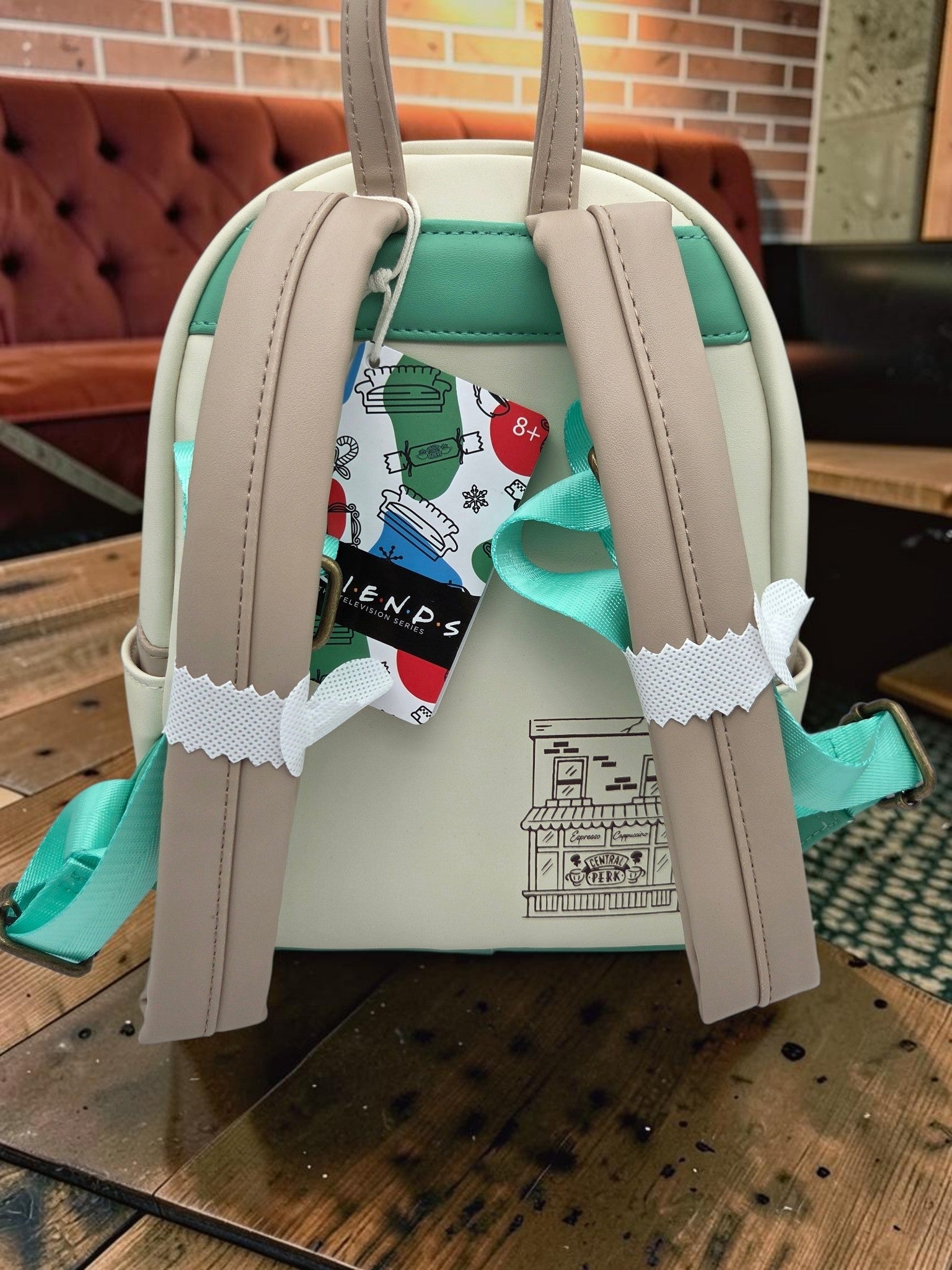 Momof2boyz Shop Friends Central Perk mini backpack featuring cream and green vegan leather with a line art back design.