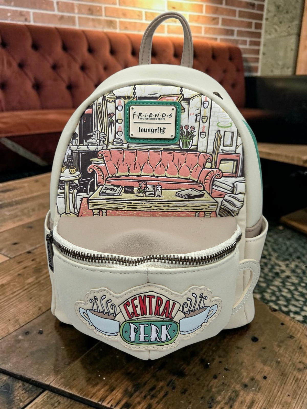Momof2boyz Shop Friends Central Perk mini backpack in cream and green vegan leather with iconic couch graphic print