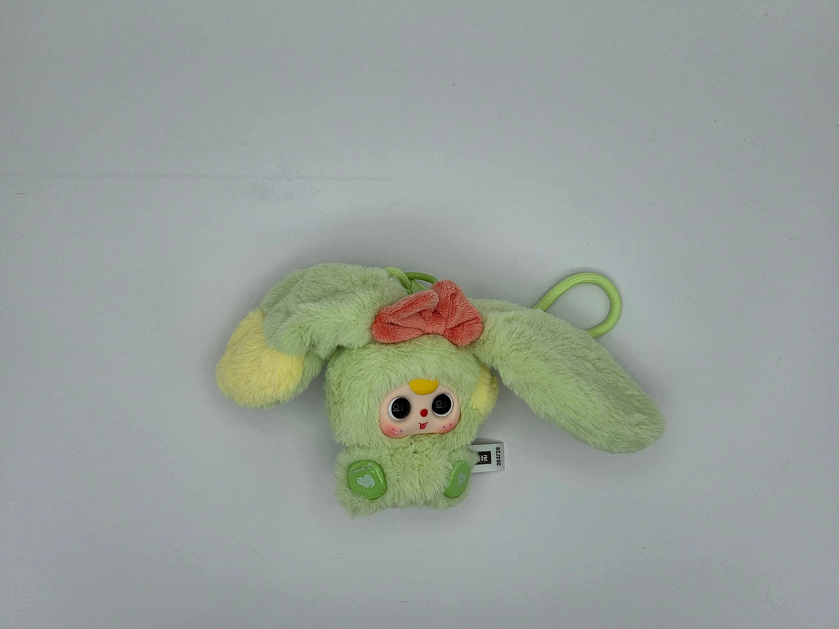 Momof2boyz Shop Baby Three Alice Rabbit Town plush keychain in light green with a pink bow and floppy ears.