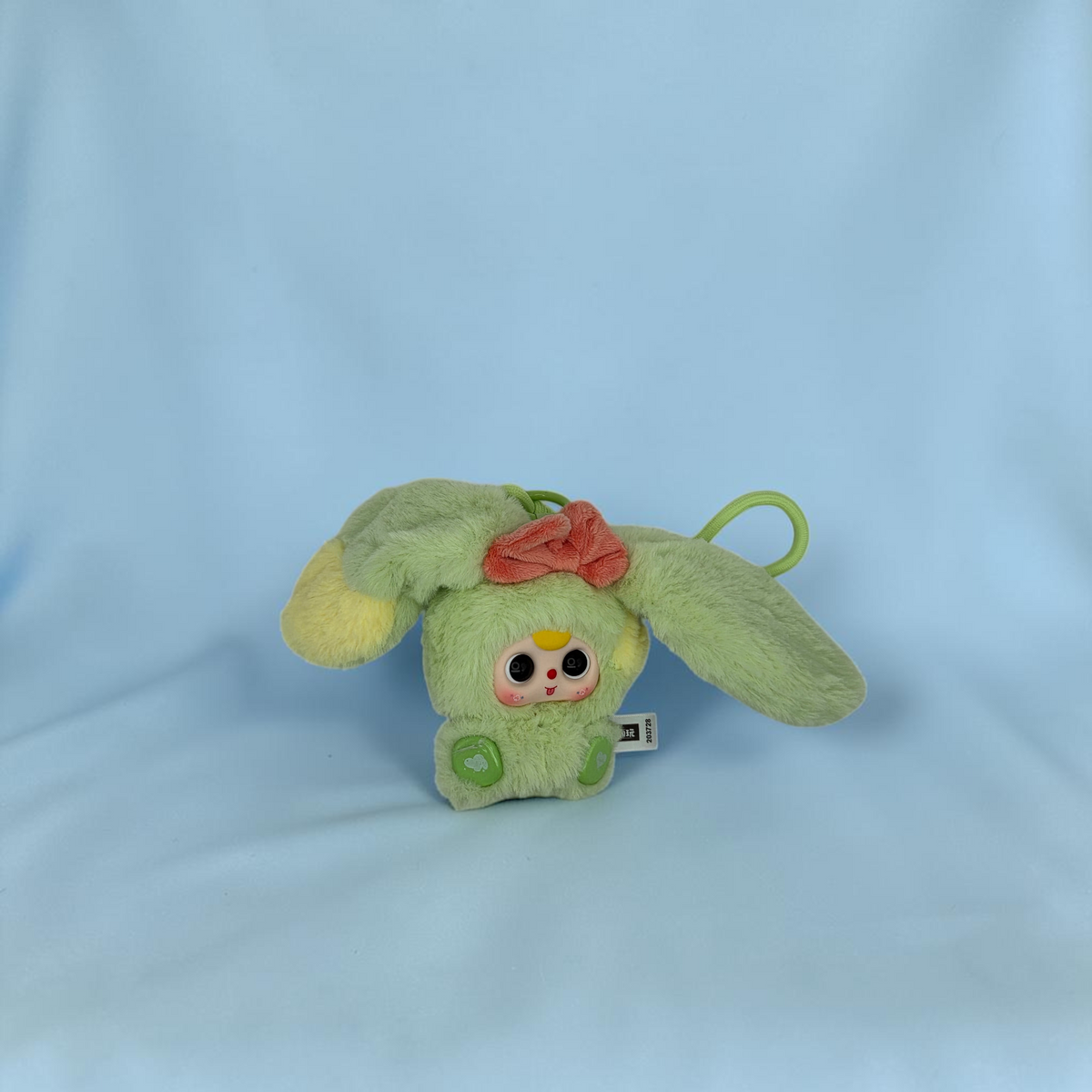 Momof2boyz Shop Baby Three Alice Rabbit Town plush keychain in light green with a pink bow and floppy ears.
