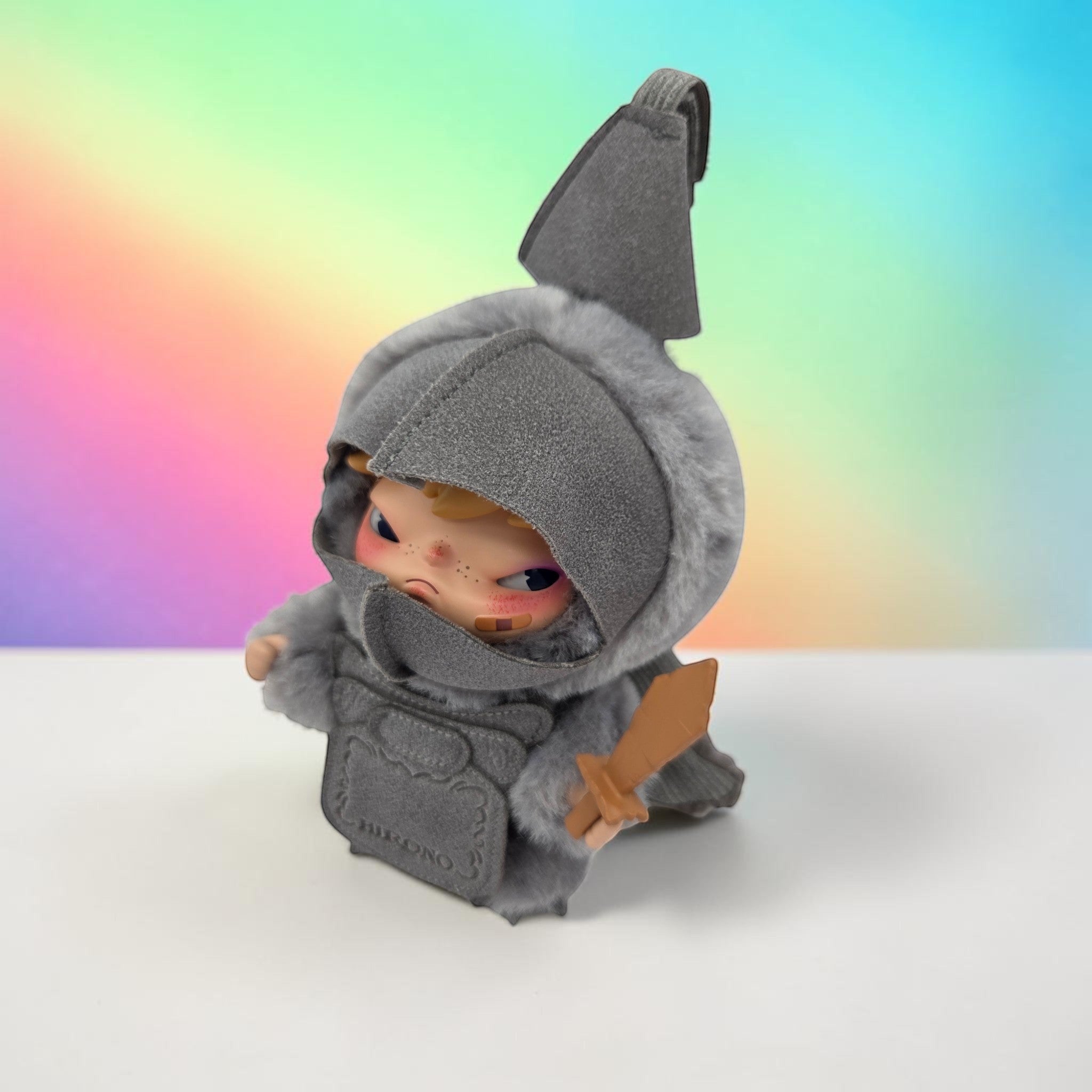 Momof2boyz Shop HIRONO Mist Walker art toy figure in a grey faux-fur hooded knight costume with a small wooden sword.