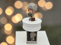Momof2boyz Shop Hirono Tamed Wildgrass figure, newspaper-wrapped head, holding phone, briefcase, commentary on digital age.