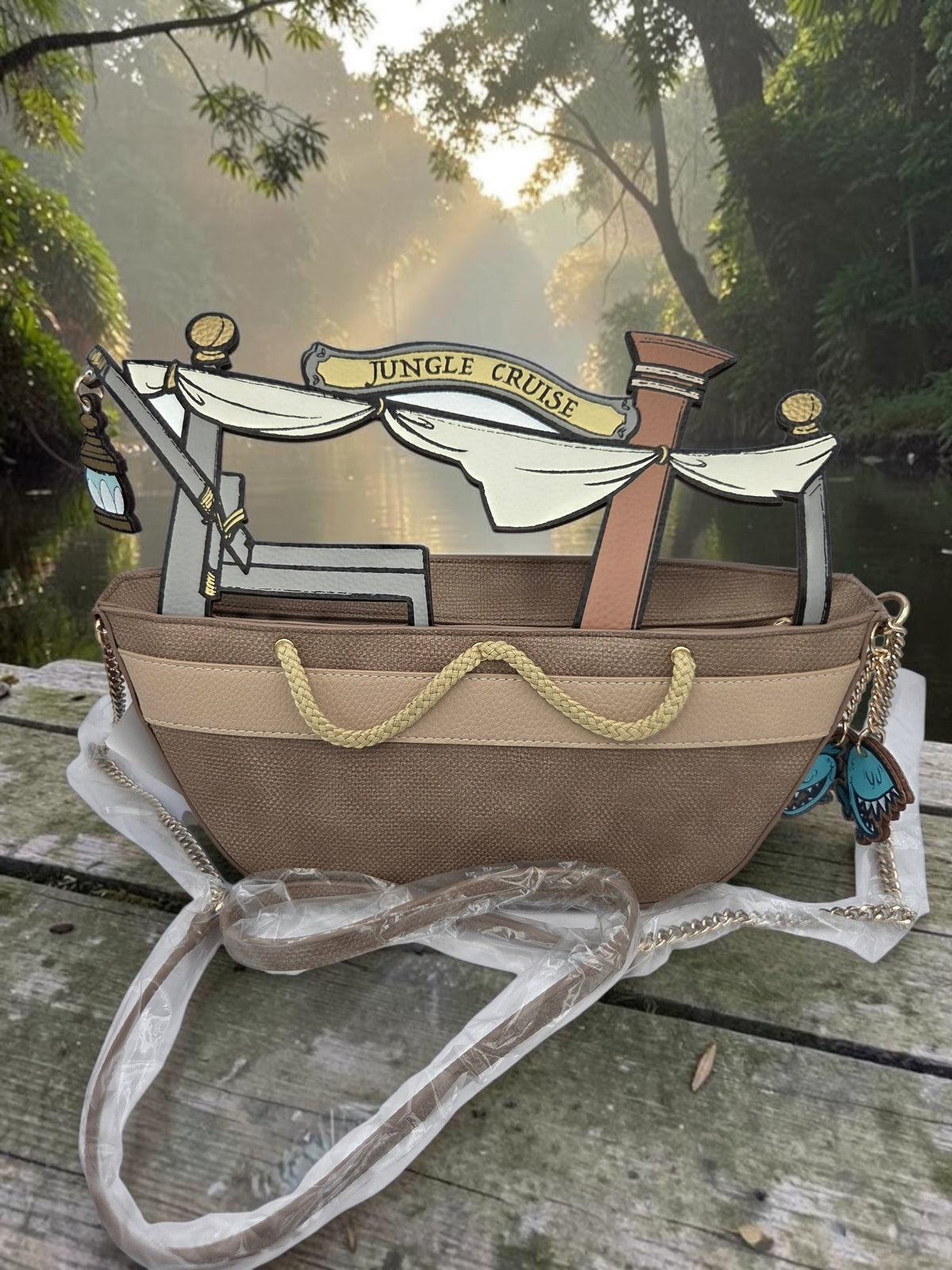 Momof2boyz Shop Disney Jungle Cruise crossbody bag with 3D boat cutout and piranha charm on a wooden dock