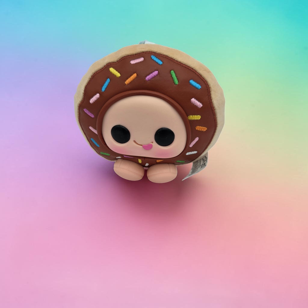 Momof2boyz Shop Krispy Kreme doughnut plush toy with brown frosting, colorful sprinkles, and a cute expressive face.