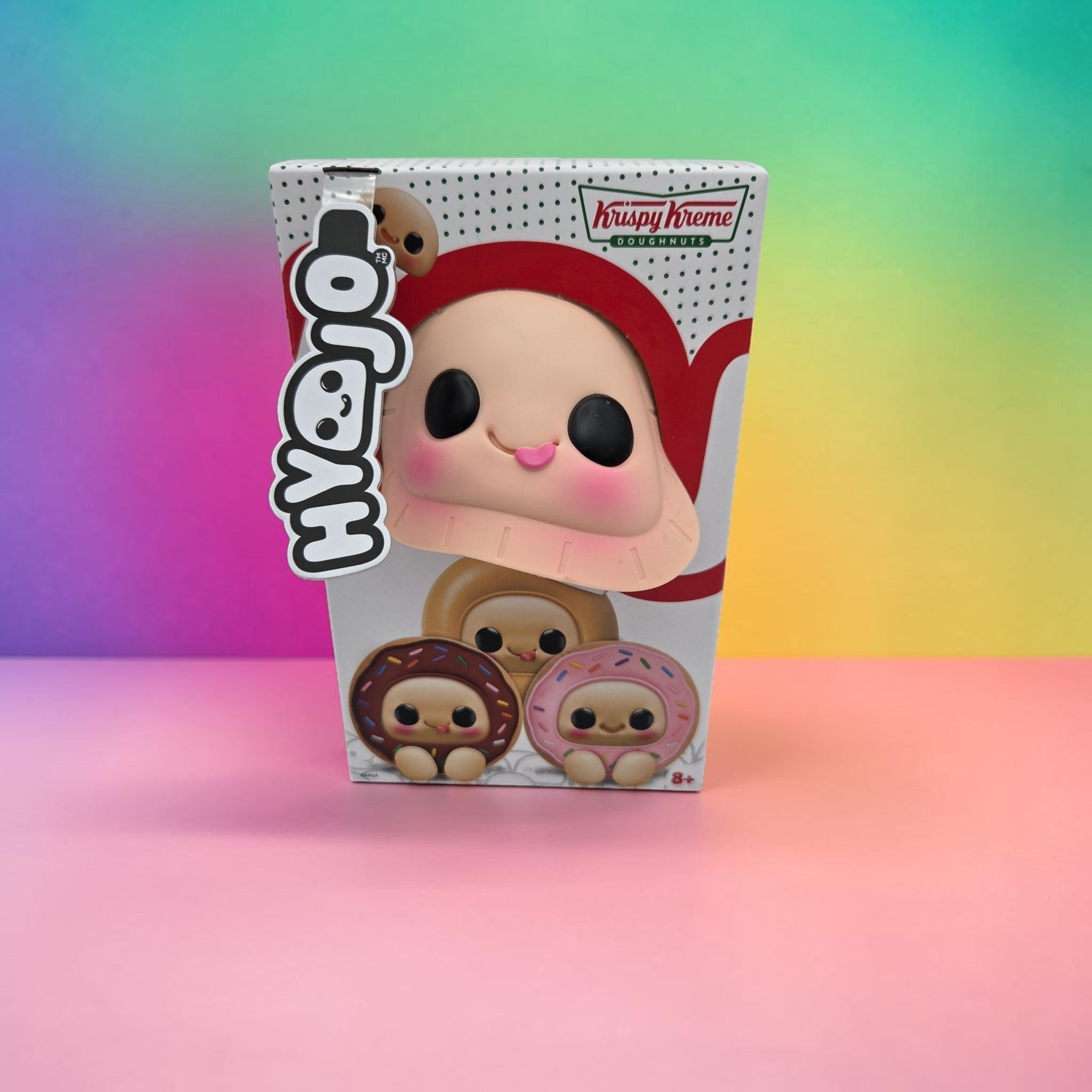 Momof2boyz Shop Krispy Kreme doughnut collectible plush toy in its branded display box with colorful background
