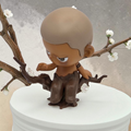 Momof2boyz Shop Popmart Kubo Breathing In Winter's Clarity figure sitting on a brown tree branch with white flowers.