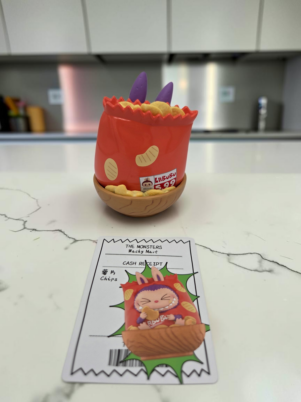 Momof2boyz Shop Labubu Monster's Wacky Mart chips collectible figure with character card on a kitchen counter