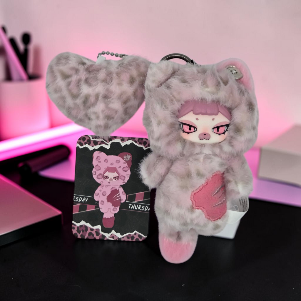 Momof2boyz Shop Thursday plush keychain with leopard faux fur, pink accents, heart charm, and collector card.