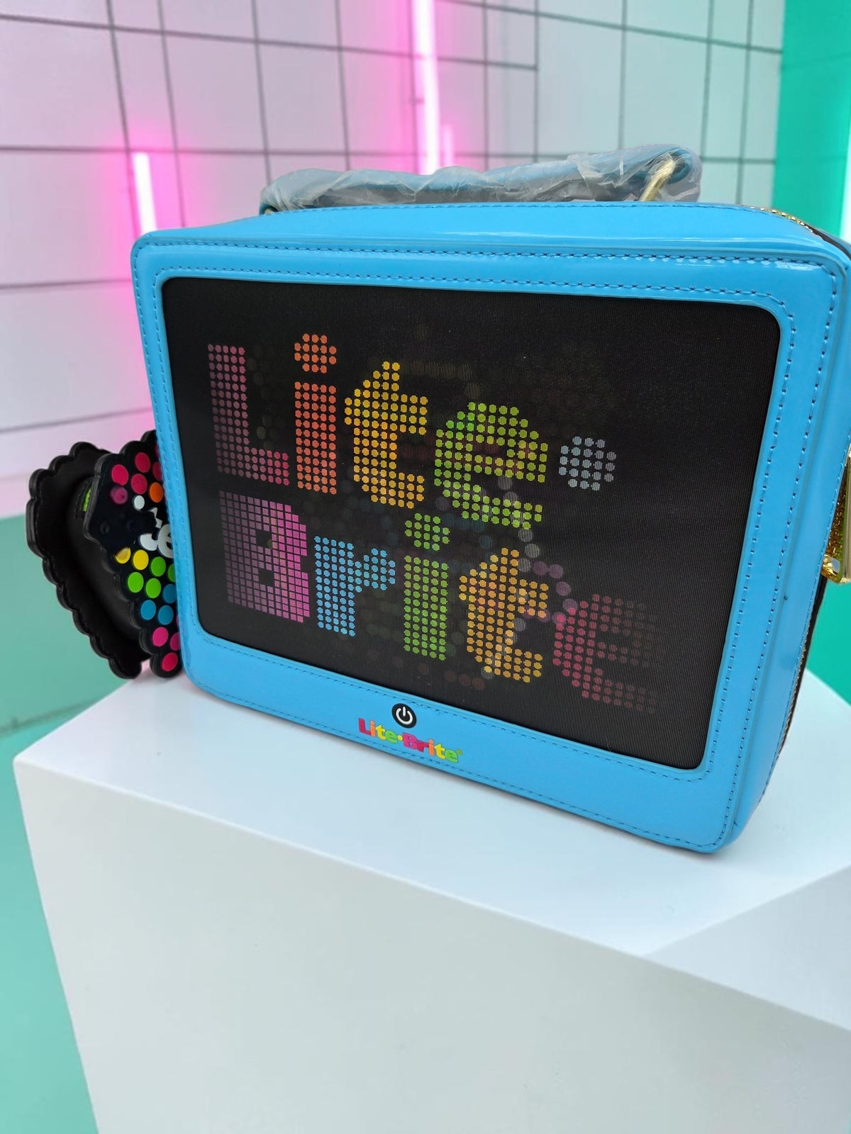 Momof2boyz Shop Lite-Brite blue crossbody bag with a retro toy-inspired pixelated display and heart coin purse.