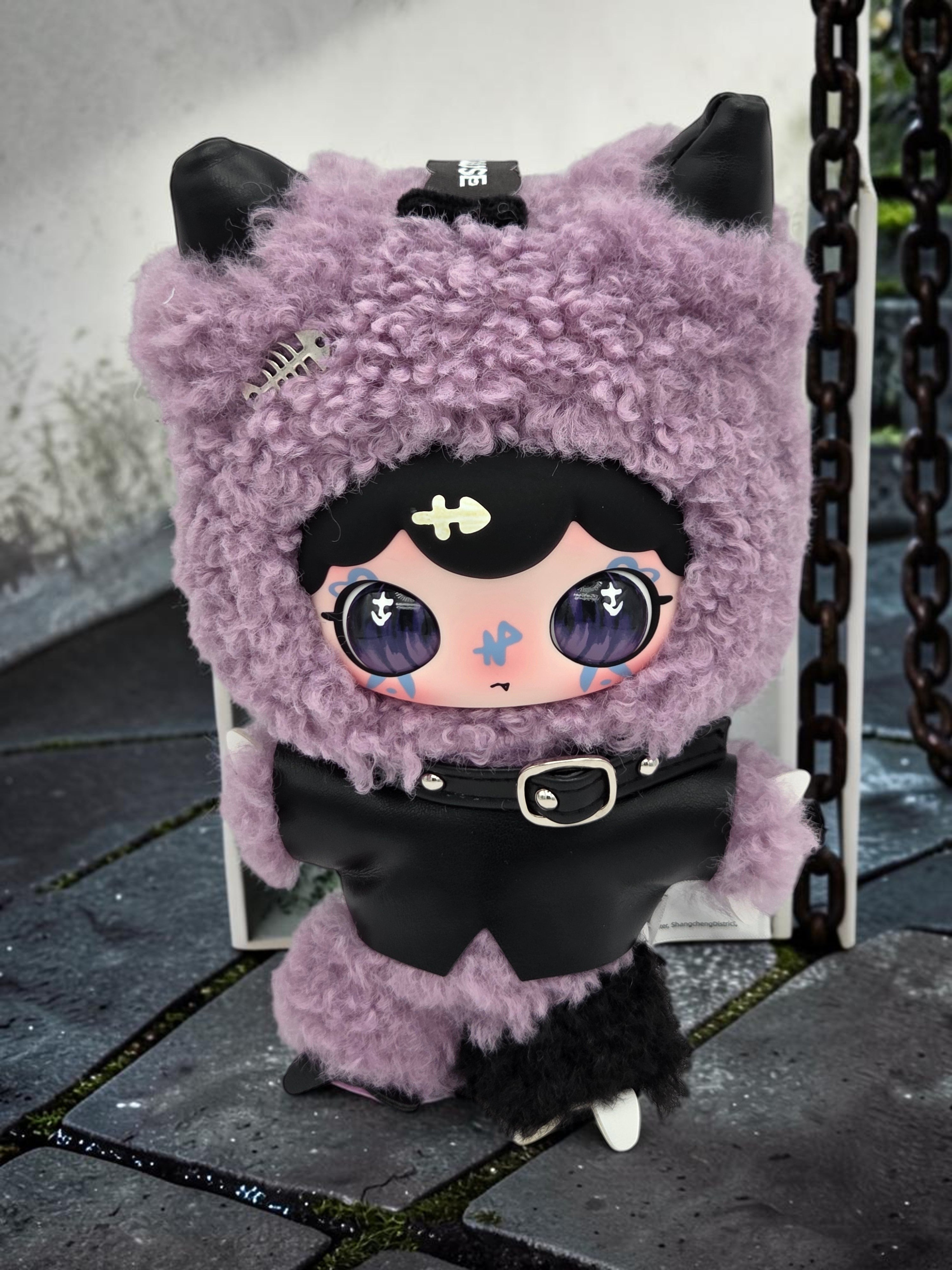 Momof2boyz Shop Lulumi The Seventh Pain plush toy in purple faux fur with a black leather vest and gothic details.