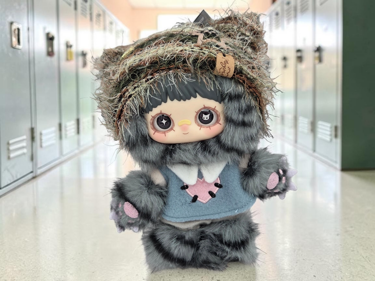 Momof2boyz Shop Maymei Kitten Academy Confirmed Cheesy Kitten plush figure with grey fur and blue vest in a hallway.