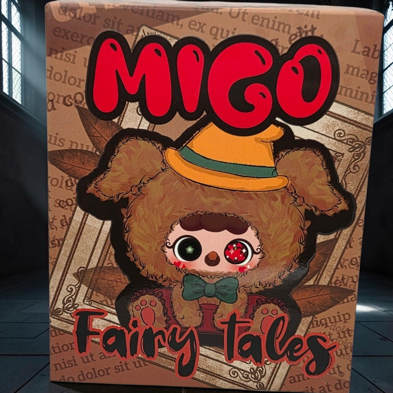 Momof2boyz Shop Migo Fairy Tales King's New Clothes plush box featuring a cute brown furry character with a yellow hat