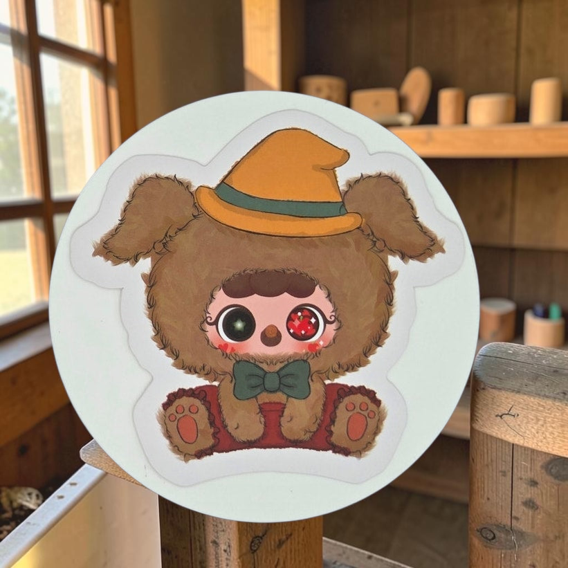 Momof2boyz Shop Migo Fairy Tales Confirmed A White Lie plush sticker featuring a brown fuzzy character in a yellow hat