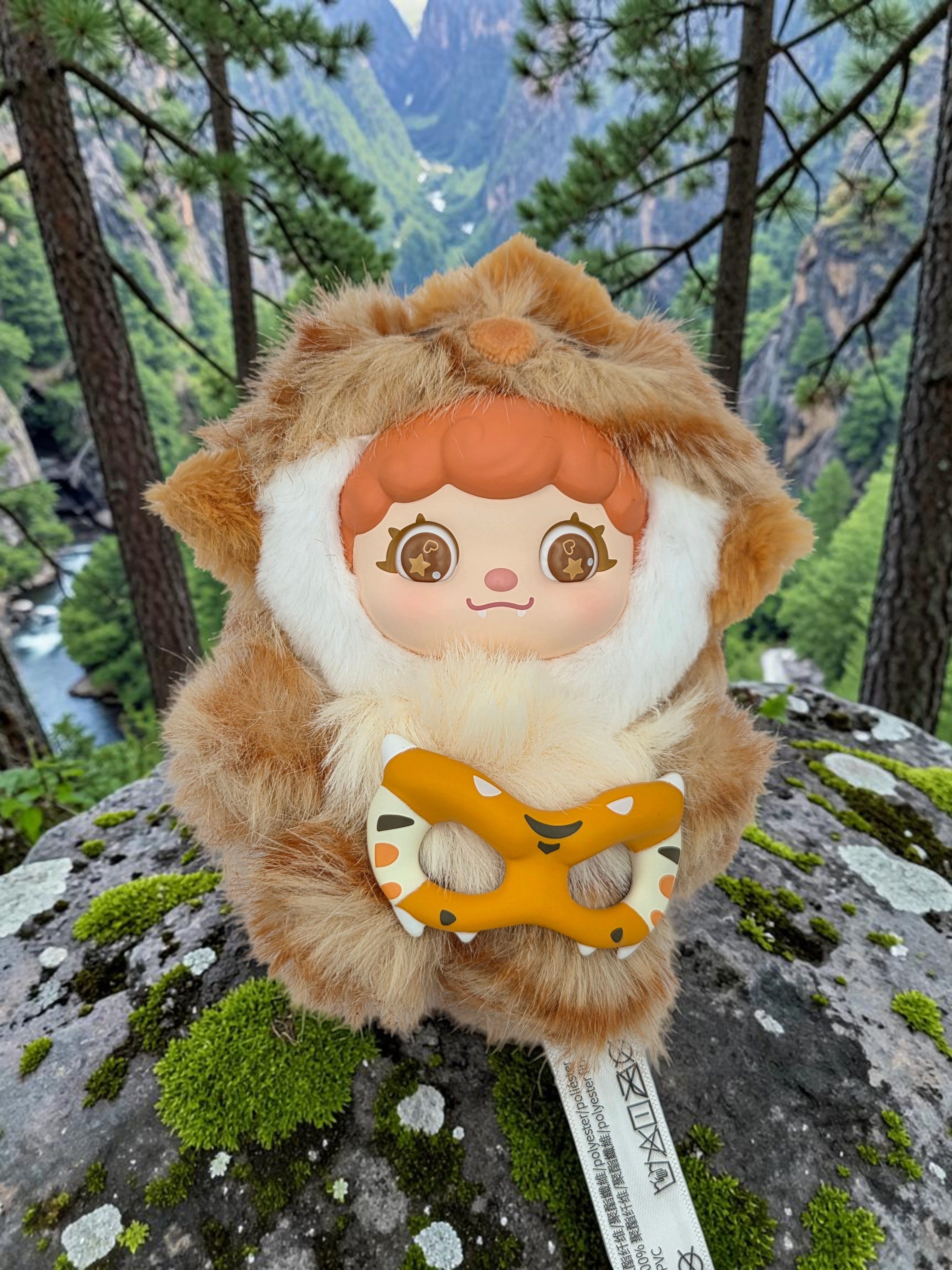 Momof2boyz Shop Mochi Little Monster plush keychain featuring a cute character with a tiger mask on a mossy rock