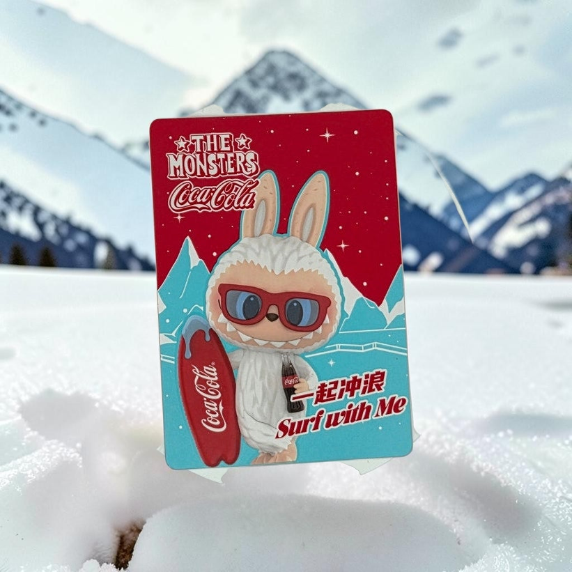 Momof2boyz Shop The Monster's Coca-Cola figure card featuring a white yeti character with sunglasses and a surfboard.