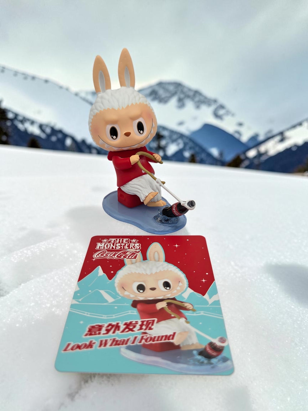 Momof2boyz Shop The Monster's Coca-Cola rabbit figure fishing on a blue base with matching collector card in snow