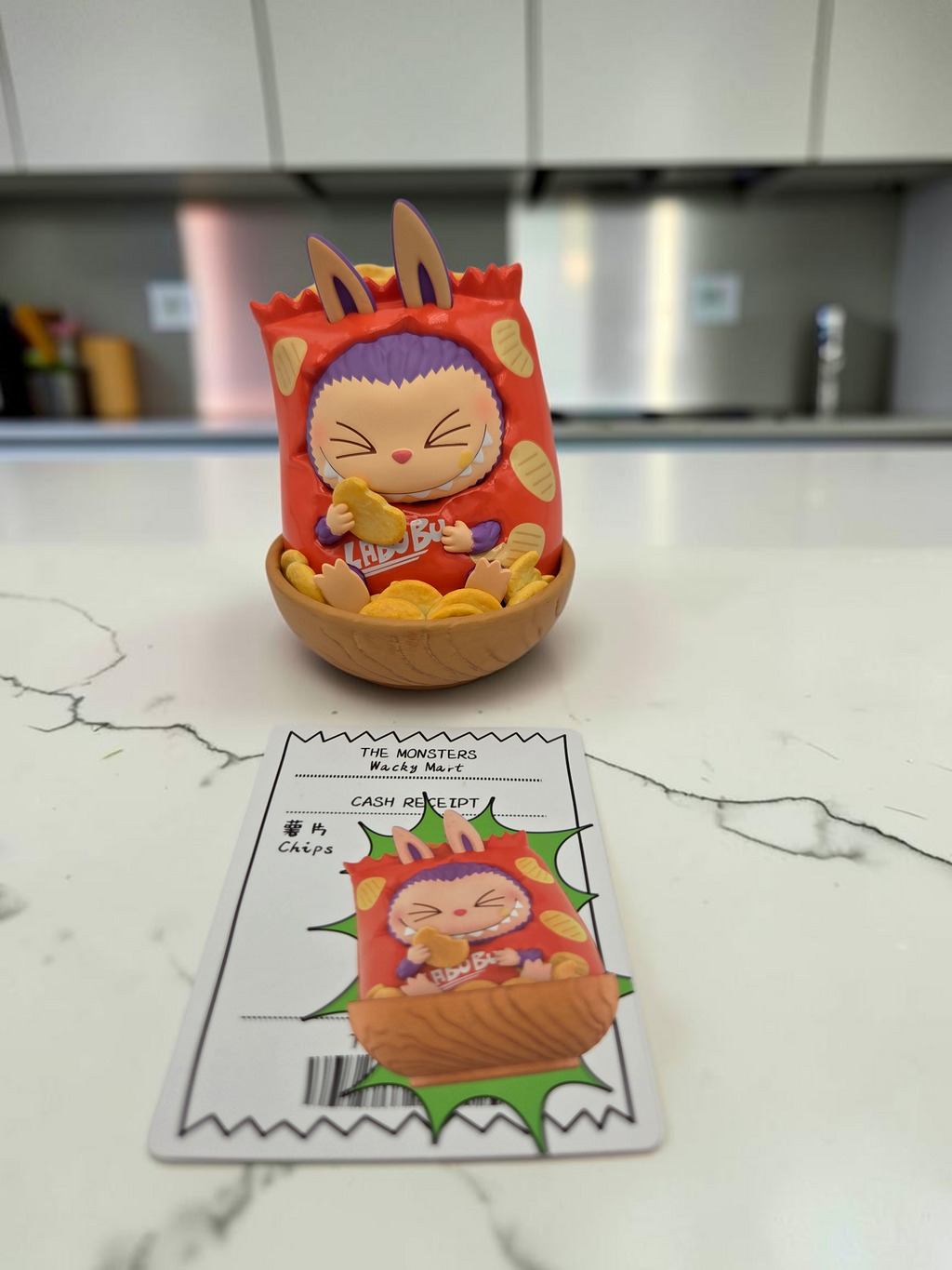 Momof2boyz Shop The Monster's Wacky Mart collectible figure in a chip bag costume with a matching receipt card.