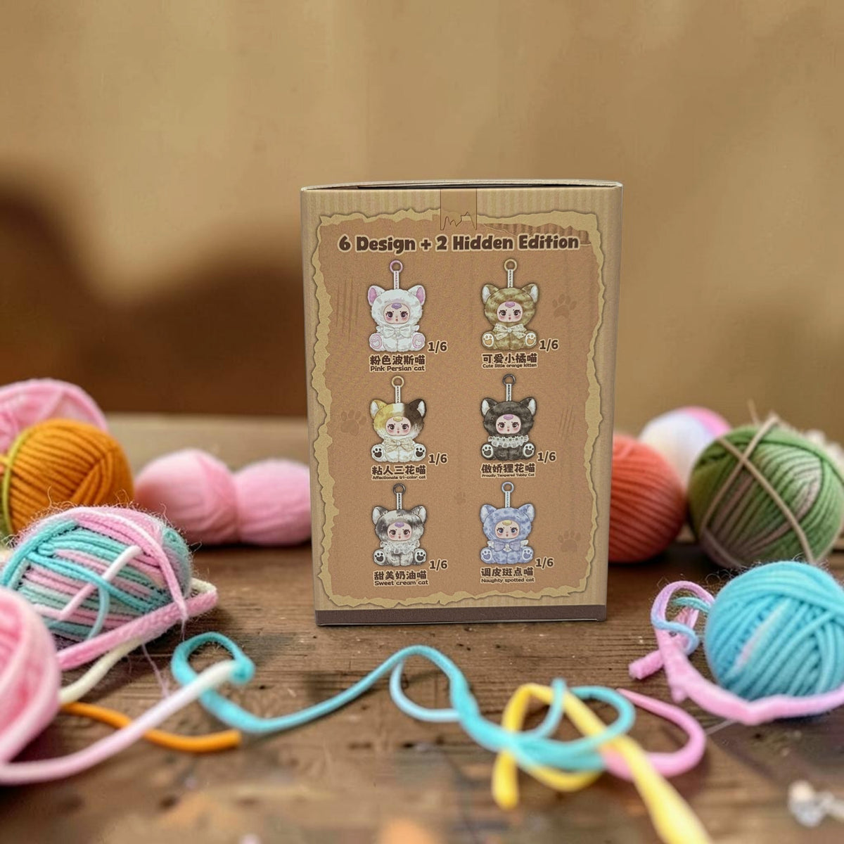 Momof2boyz Shop Naughty Kitty blind box display box showing six collectible plush kitten designs with yarn balls