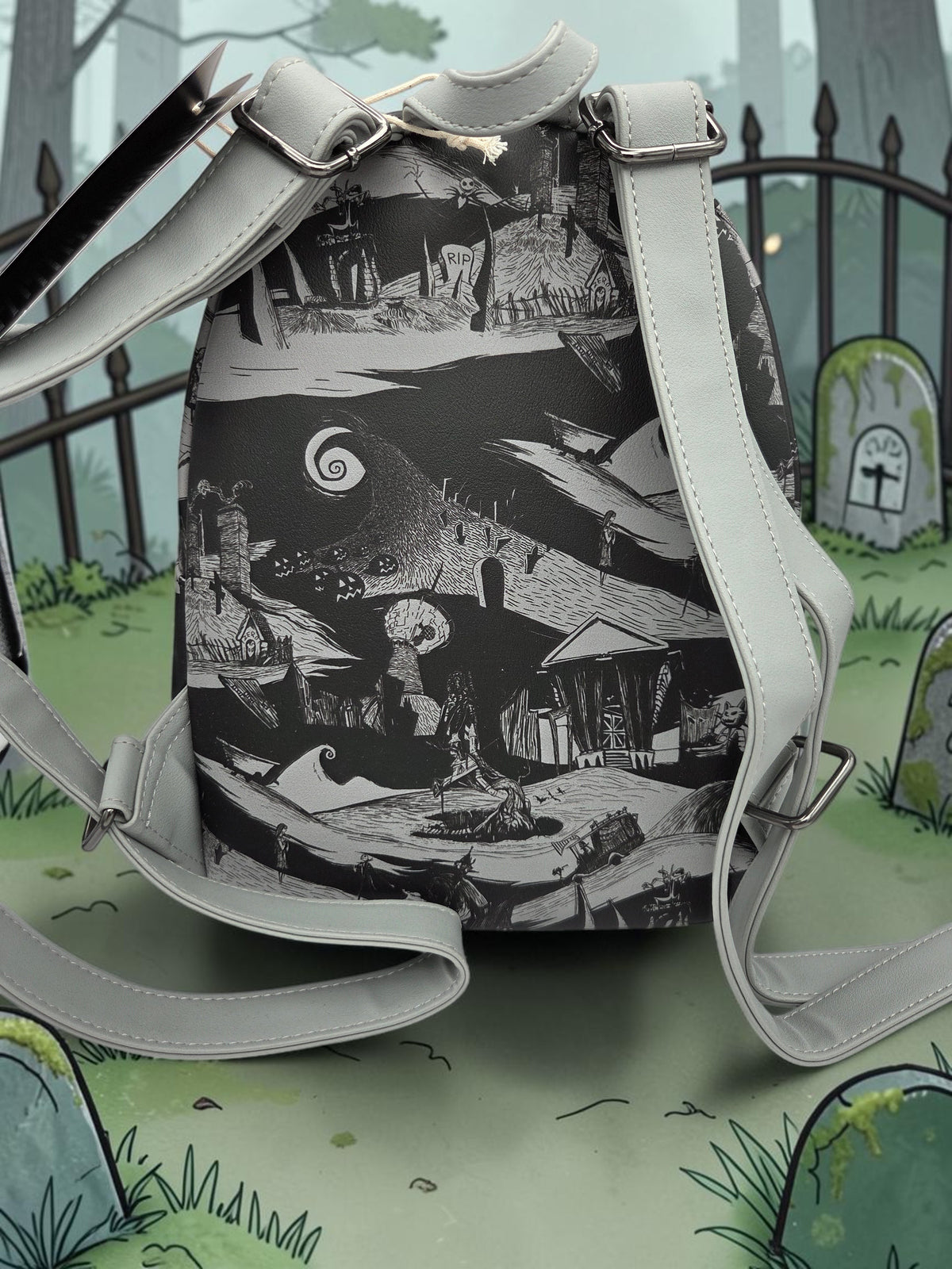 Momof2boyz Shop Nightmare Before Christmas mini backpack featuring a monochromatic graveyard scene and grey straps.