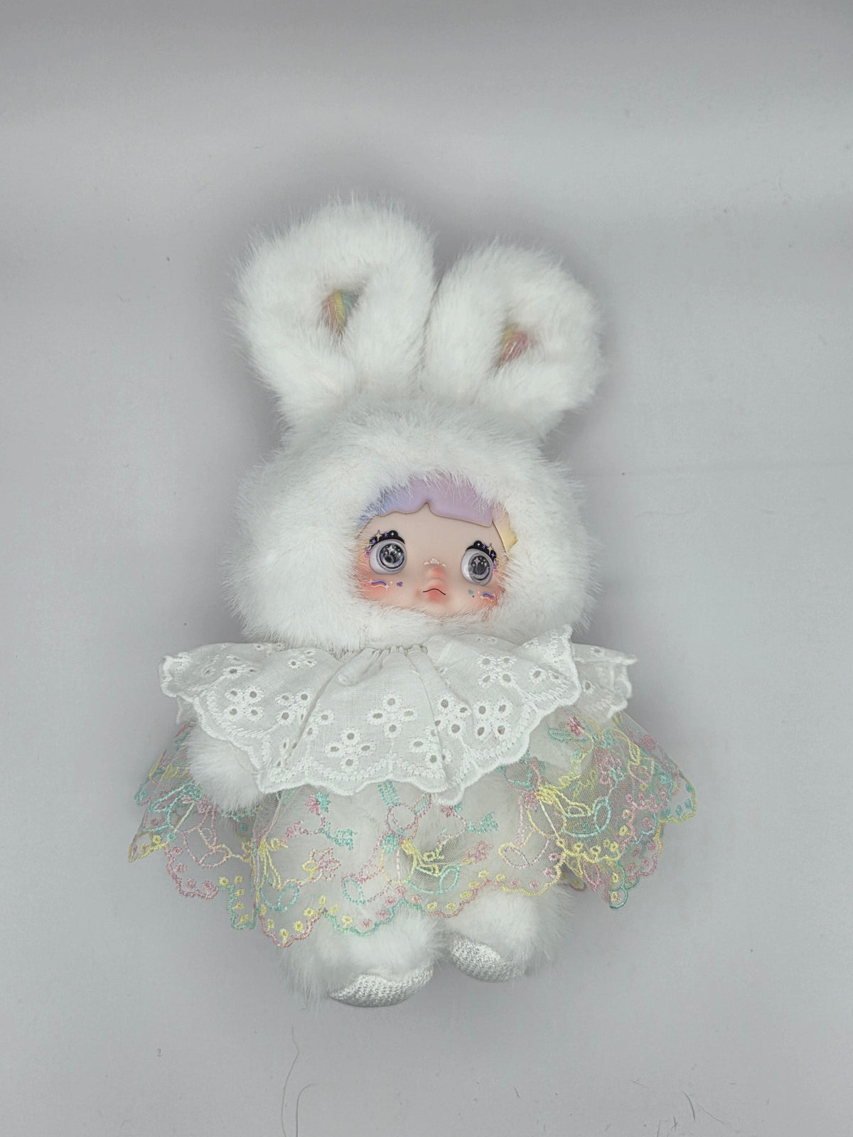 Momof2boyz Shop Nommi Weather Forecast plush doll featuring a white faux fur bunny hood and lace embroidered dress.