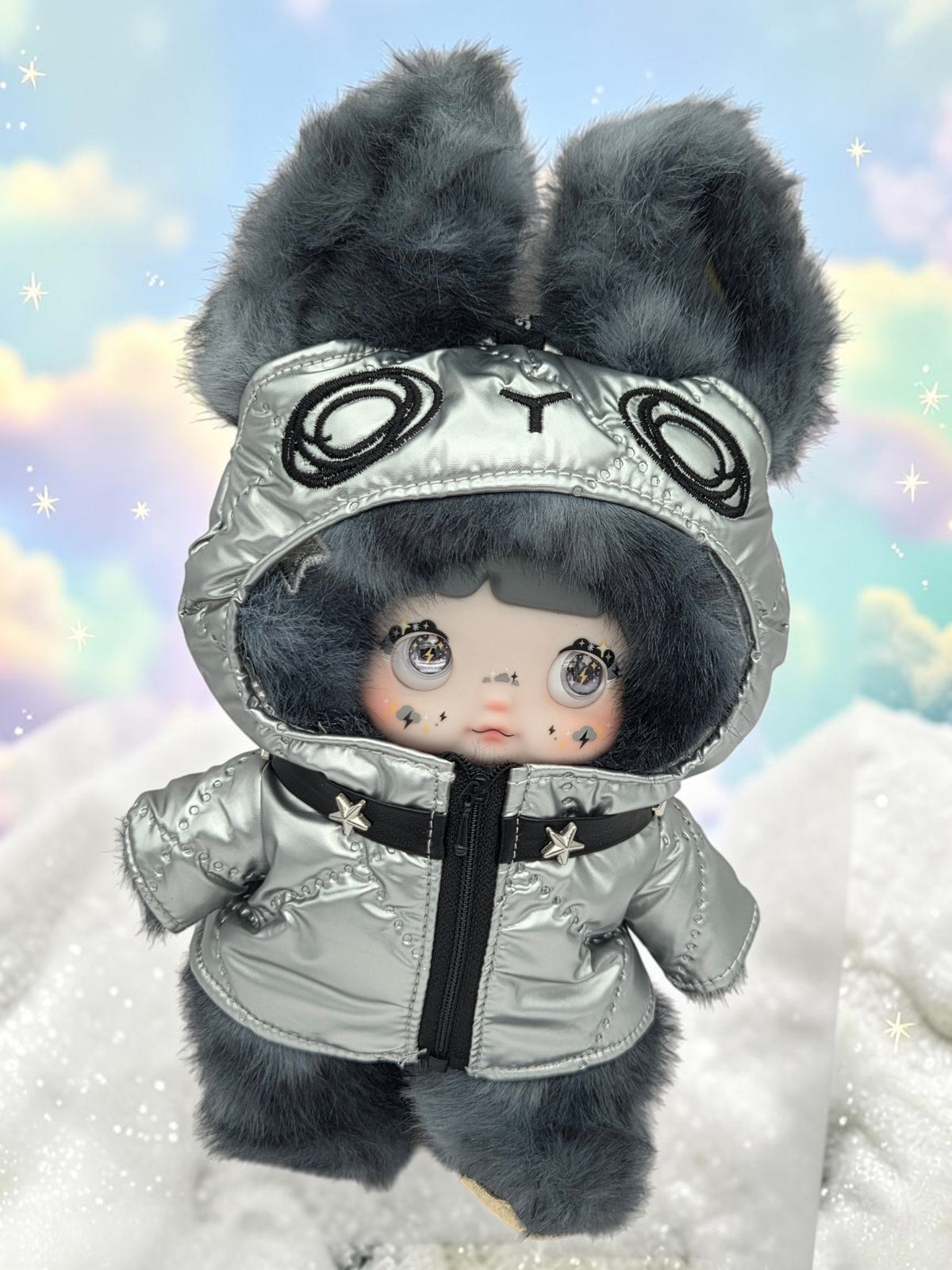 Momof2boyz Shop Nommi plush doll in a metallic silver puffer jacket with grey faux fur ears and expressive eyes.