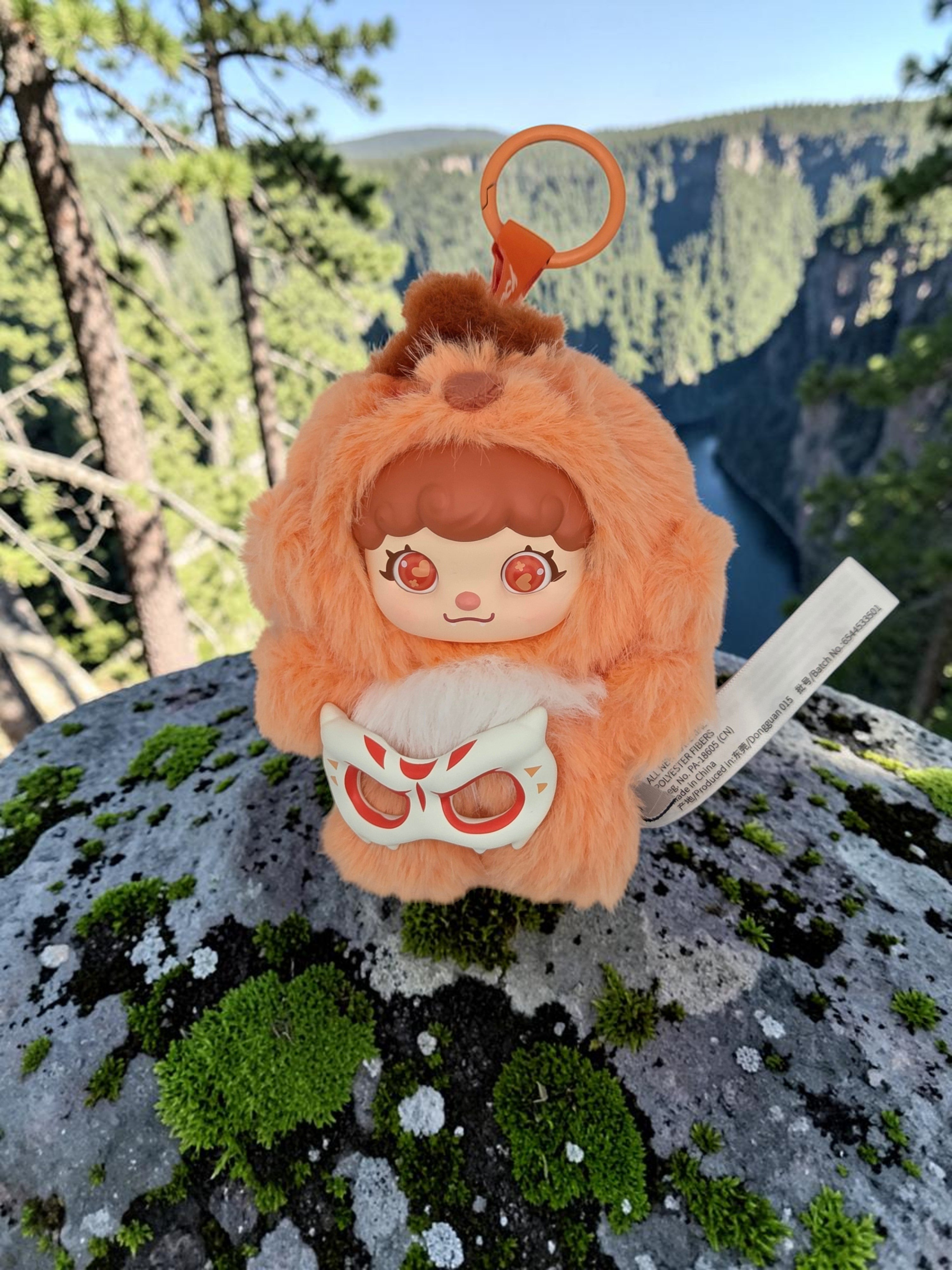 Momof2boyz Shop Mochi Little Monster plush keychain featuring an orange furry character with a removable mask