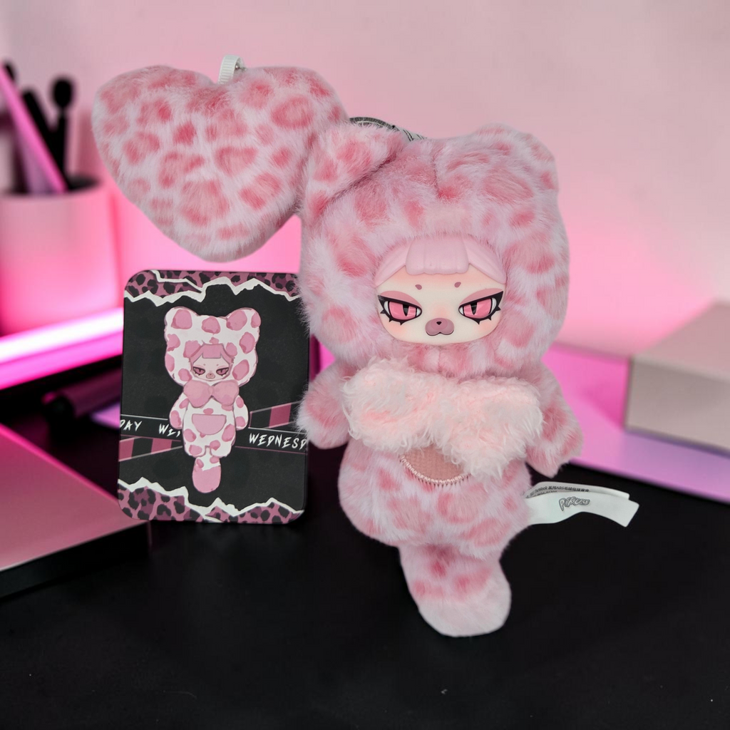 Momof2boyz Shop pink leopard print plush keychain with heart charm and matching collector card from The Week series.