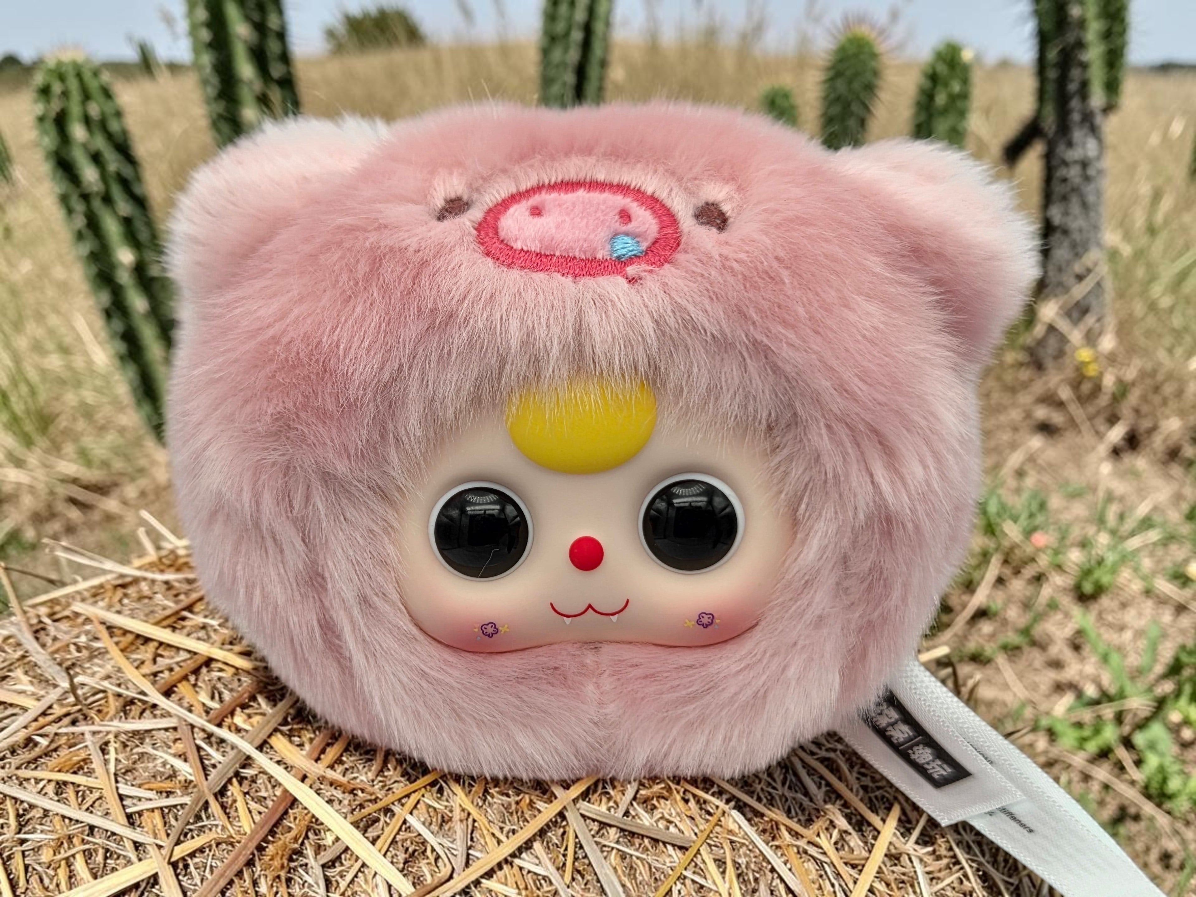 Momof2boyz Shop pink fuzzy pig zodiac collectible figure with large black eyes and yellow hair accent.