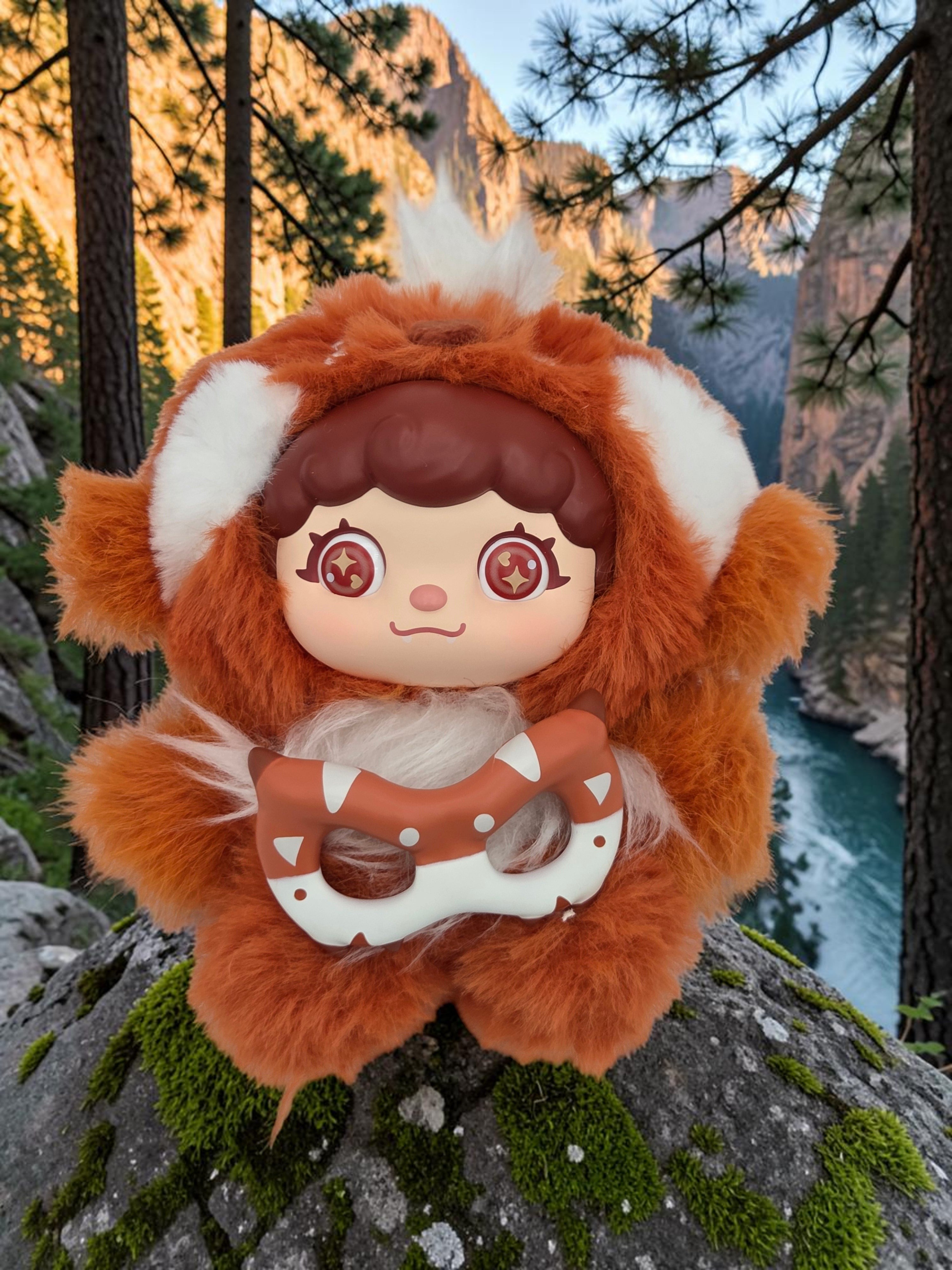 Momof2boyz Shop Mochi Little Monster Sunny Red Panda plush keychain with removable mask on a mossy rock in nature