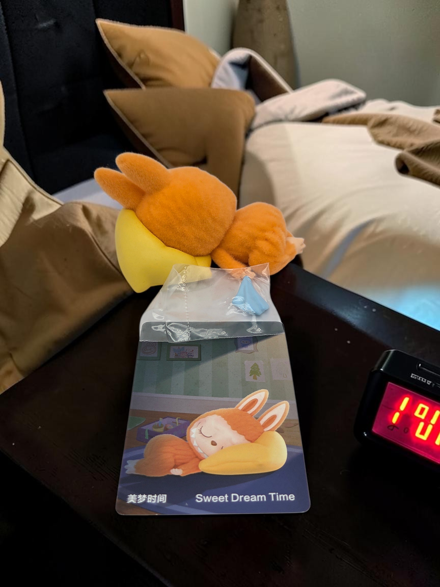 Momof2boyz Shop The Monster's 1:00 am collectible figure of a sleeping orange creature on a yellow pillow