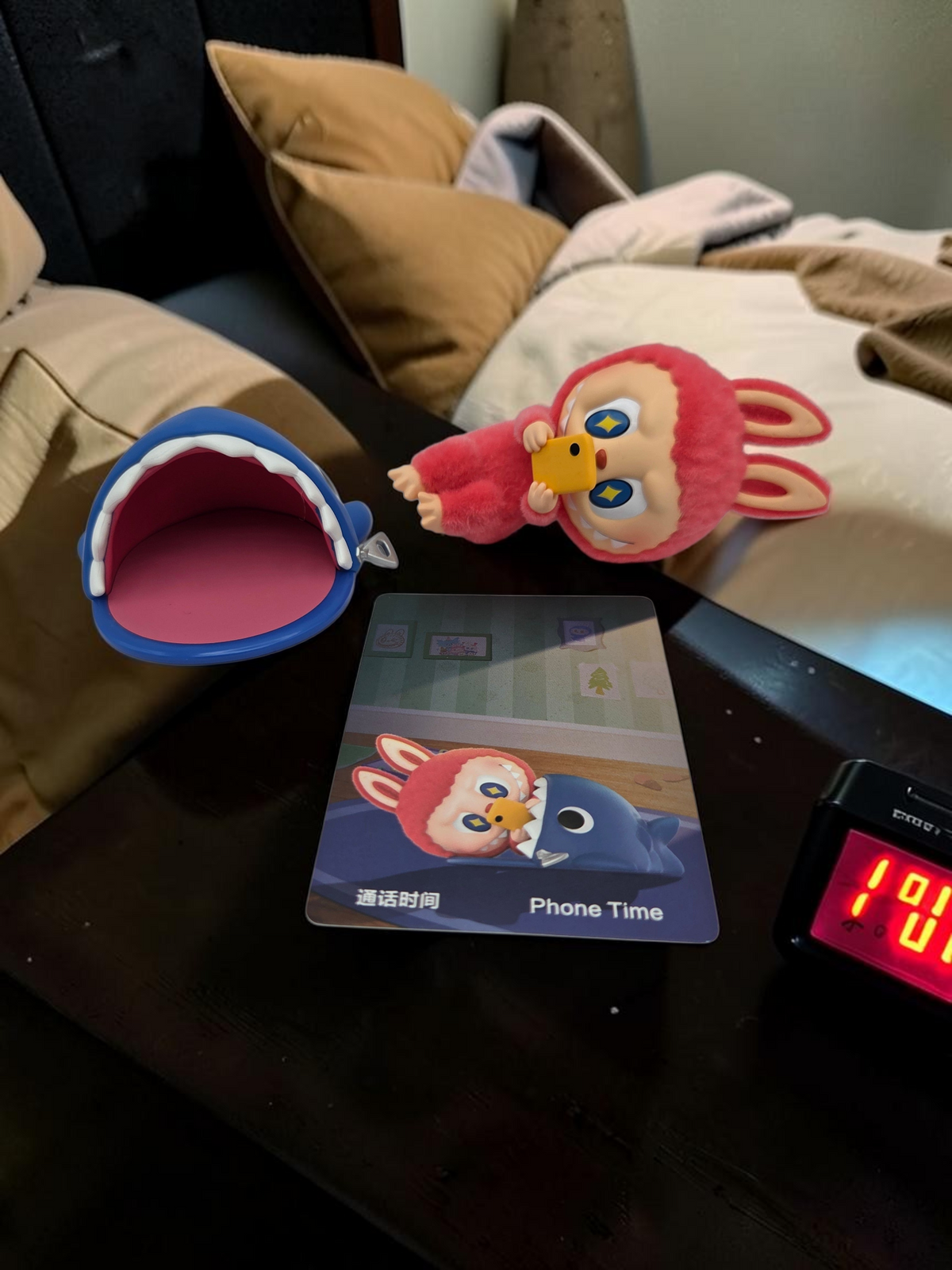 Momof2boyz Shop The Monster's 1:00 am Phone Time collectible figure with a blue shark pouch and character card.