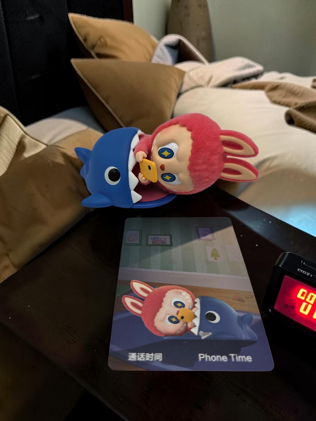 Momof2boyz Shop The Monster's 1:00 am Phone Time collectible figure featuring a pink rabbit character inside a shark